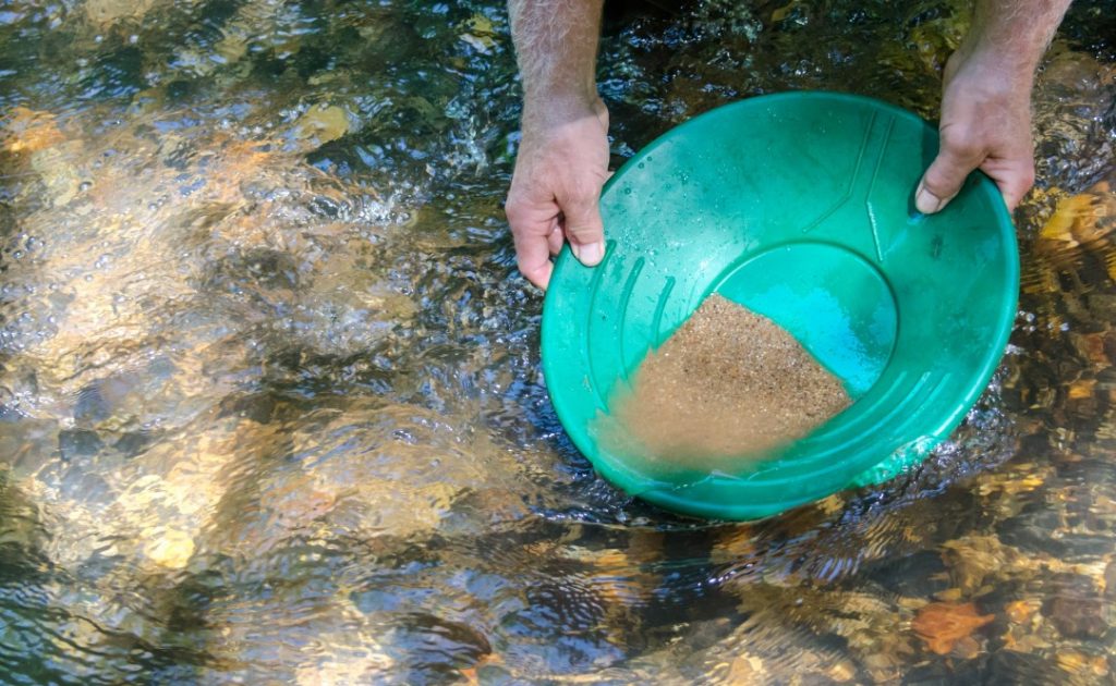 A gold pan that is used to find little gold grains in the river.