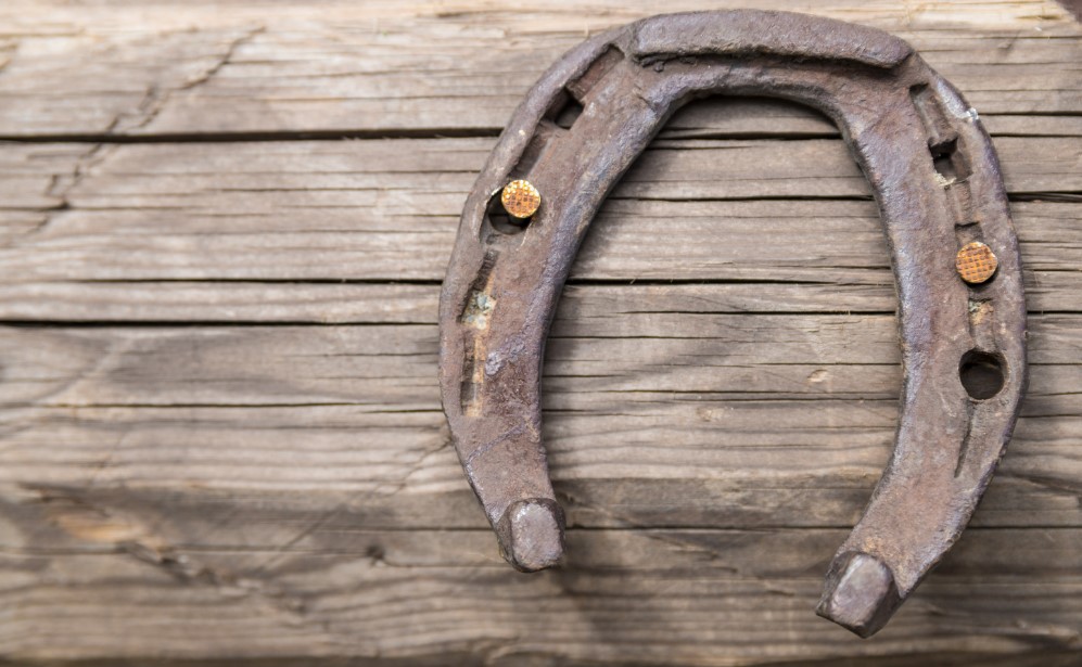 A horseshoes with 3 nail holes and uneven shapes. 