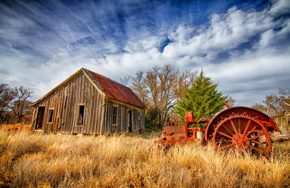 An old farm with an old plow. 