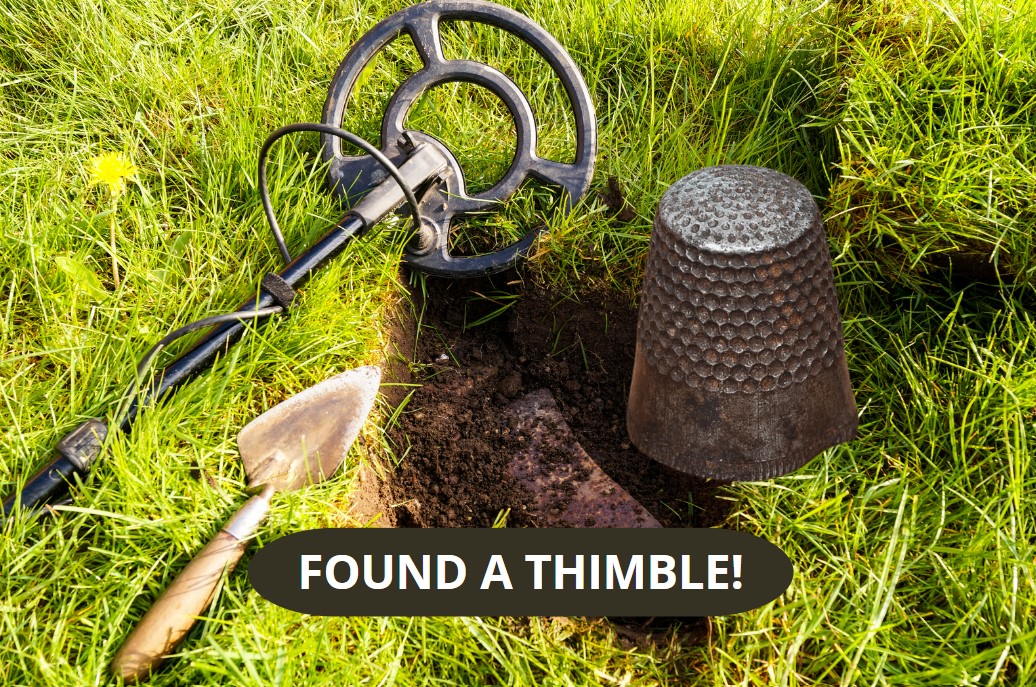 Finding a thimble with a metal detctor.